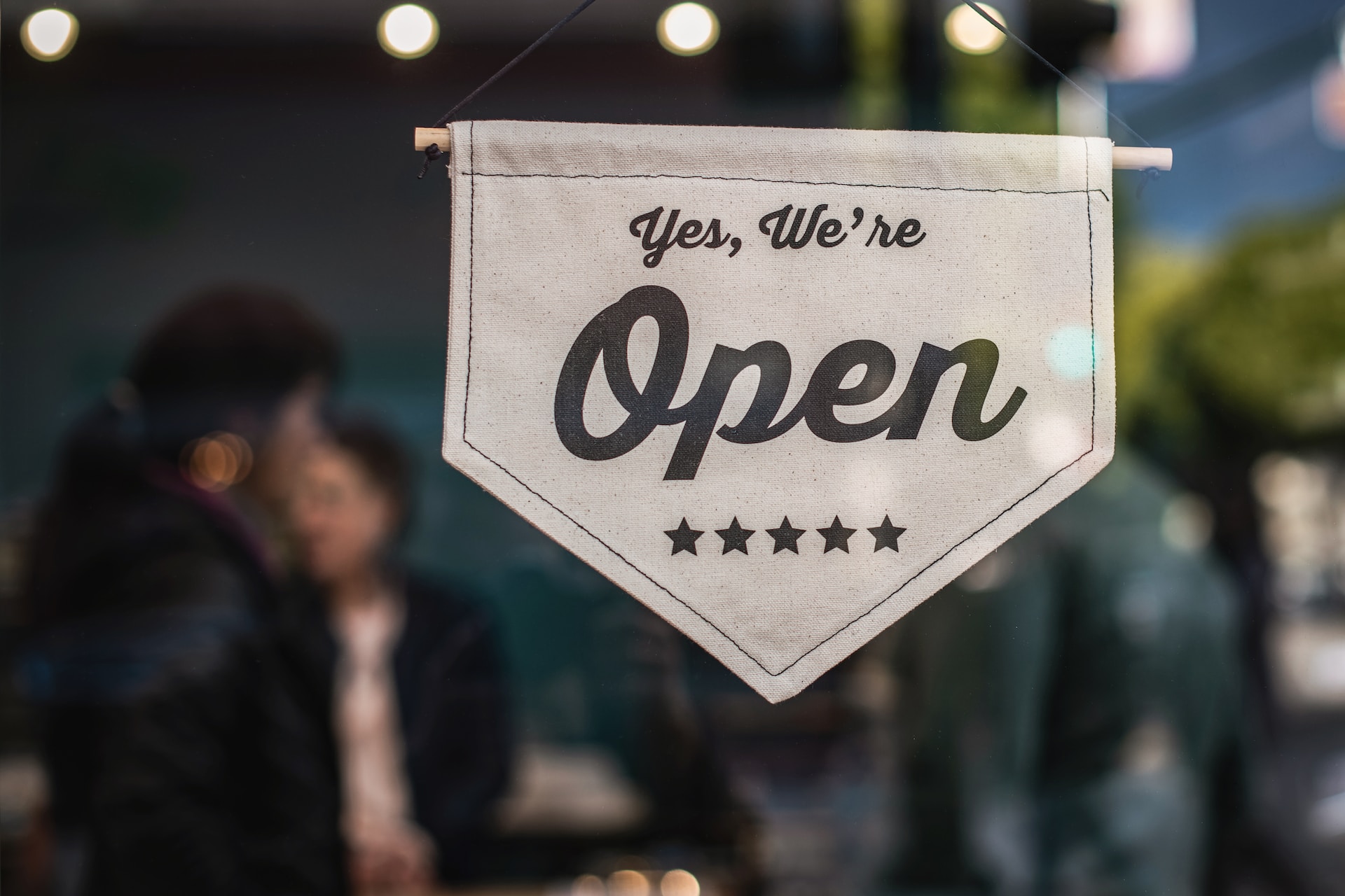 Image illustrates the fact that your book is a business with a sign that reads "Yes, we're open."