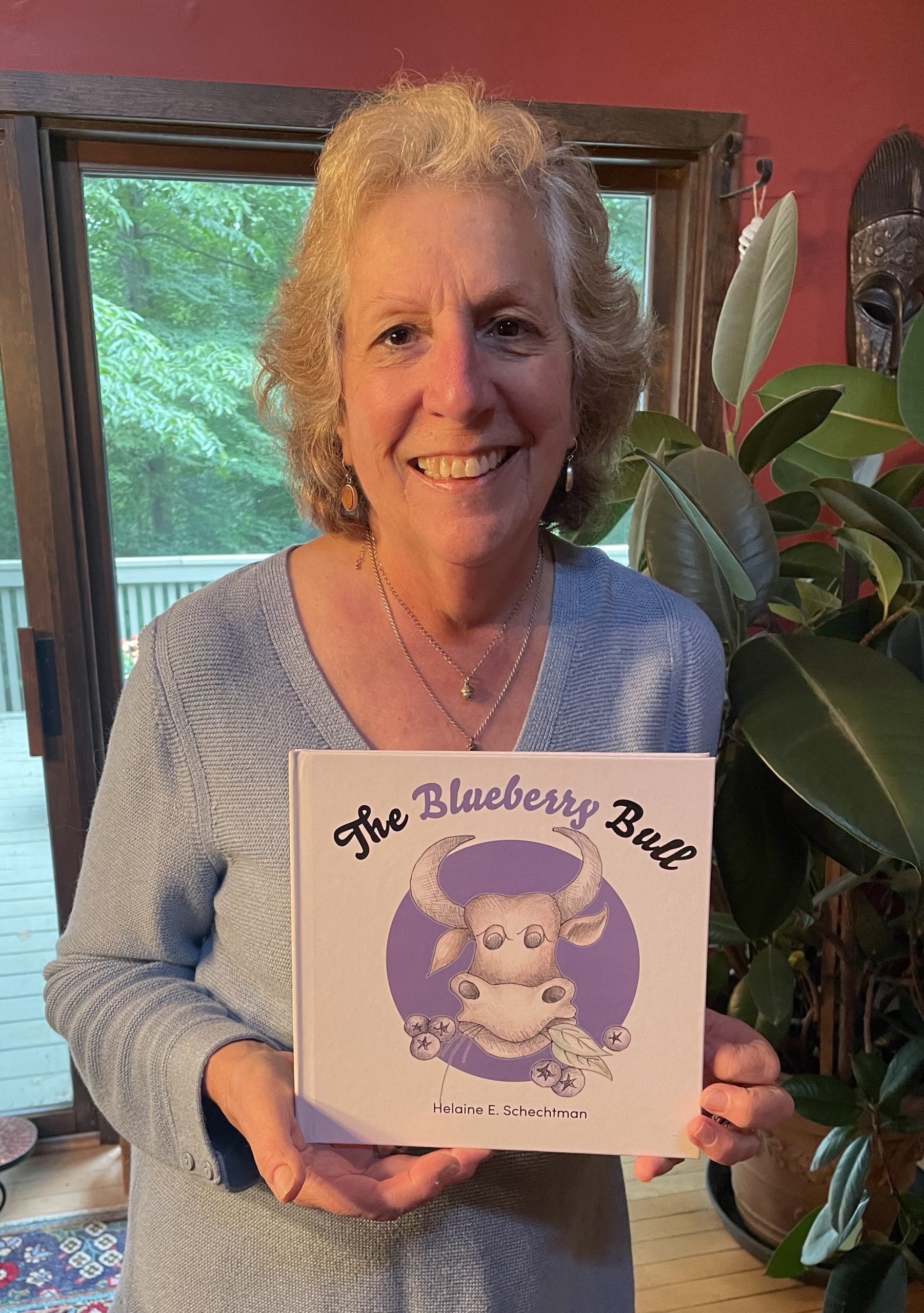 Helaine Schechtman, author of The Blueberry Bull, is pictured holding her book