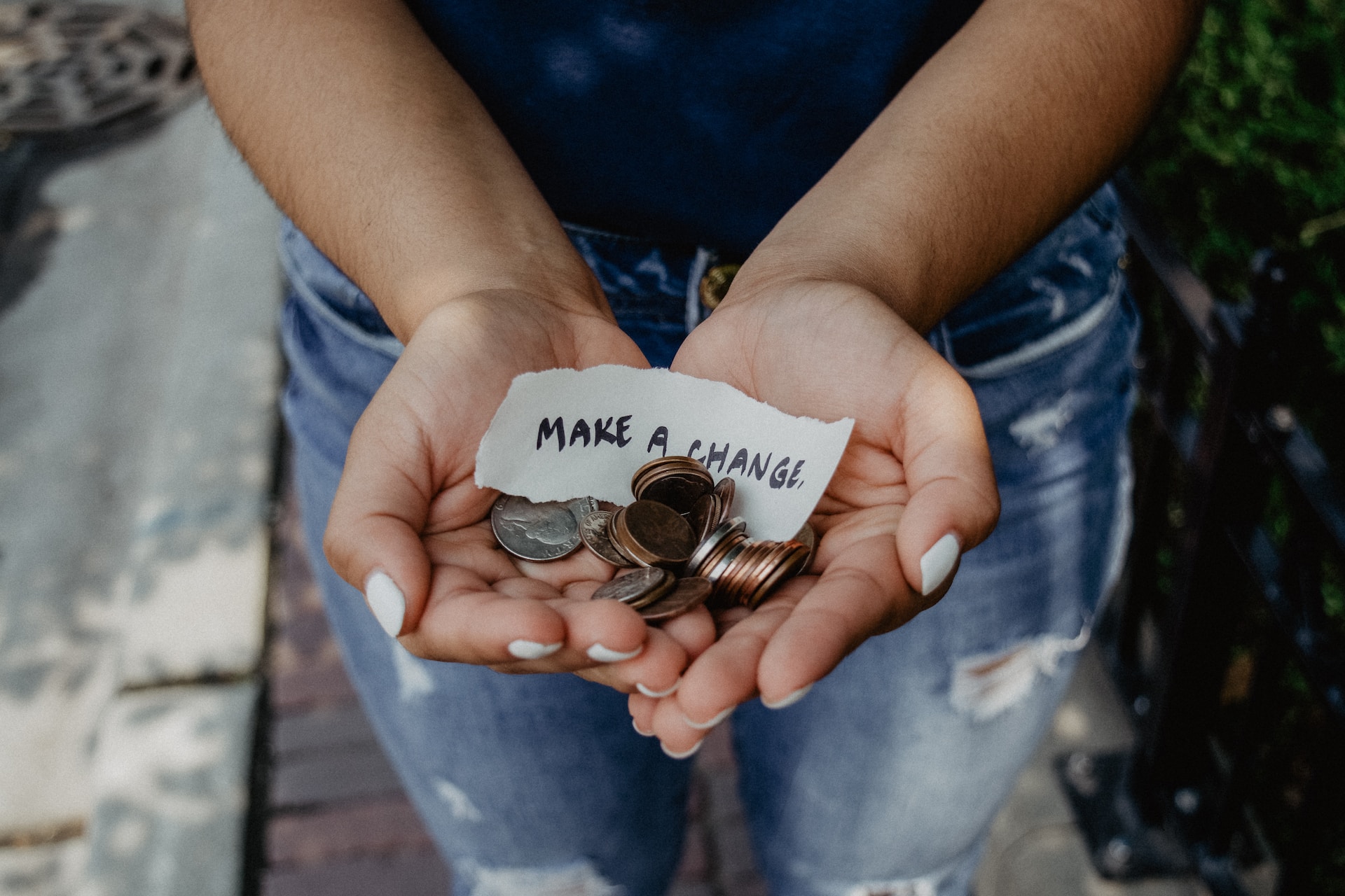 Image shows two hands holding change and a note that reads "Make change" to illustrate that authors use Kickstarter - but should they?