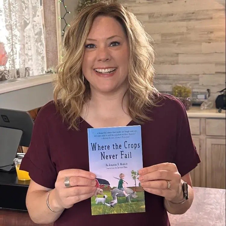 Amanda-Midkiff-holding-Where-the-Crops-Never-Fail Sarah May Author of There Is Always Hope