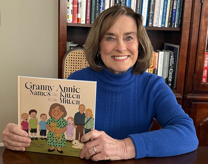 Dr. Anne Cairns Federlein with her picture book, Granny Annie Names the Kitten in the Mitten.
