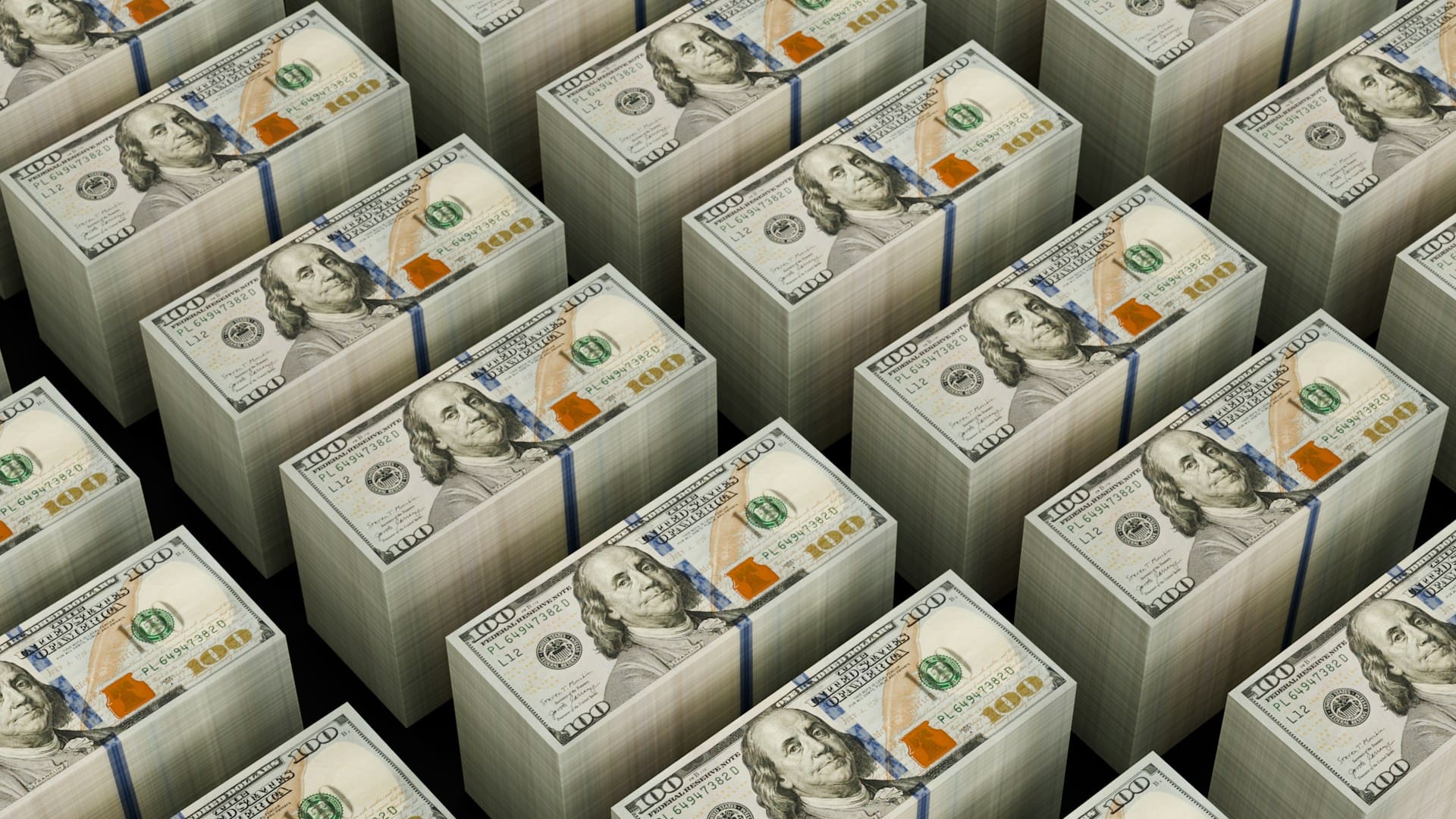 Stacks of $100 bills to illustrate the topic: What does it mean for an author to keep 100% of their royalties from book sales?
